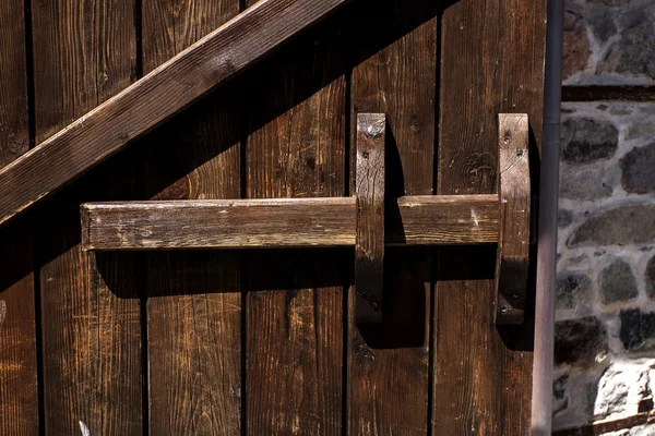 Old wooden door with wooden latch — Stock Photo, Image