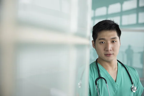 Chinese doctor wearing green scrubs