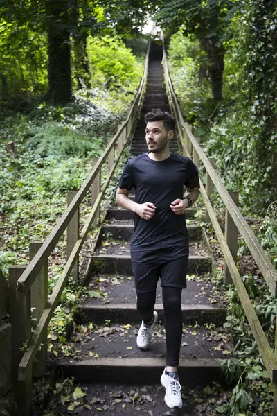 Man out running on forest trail