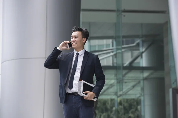 Chinese businessman using his Smartphone