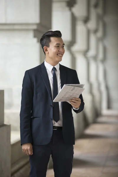 Chinese Businessman reading newspaper