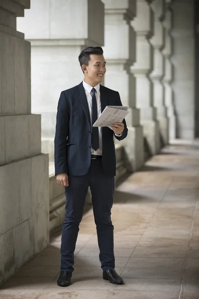 Chinese Businessman reading newspaper