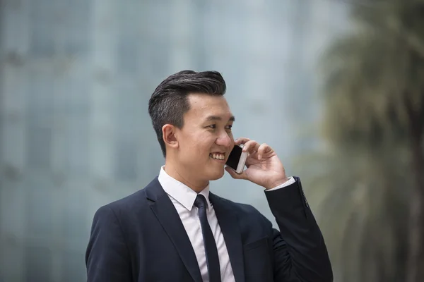 Chinese businessman using his Smartphone