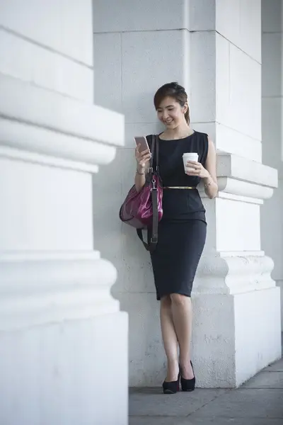 Chinese businesswoman using her smartphone