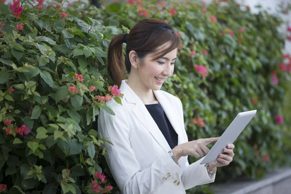 Chinese businesswoman outside using Tablet