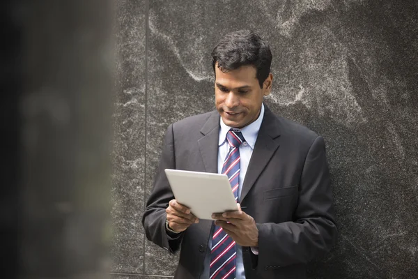 Indian businessman using tablet