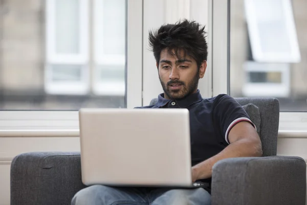 Indian man using laptop