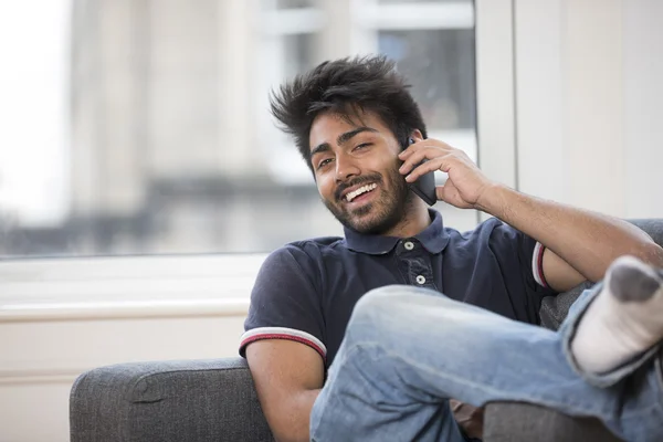 Asian Man using phone at home