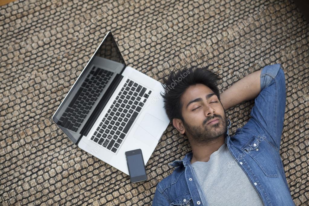 Asian man sleeping next to laptop — Stock Photo © sjenner13 123450248