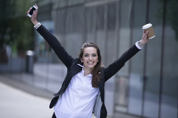 Businesswoman with arms up in the air