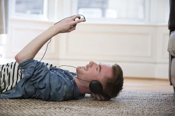 man lying on floor using phone