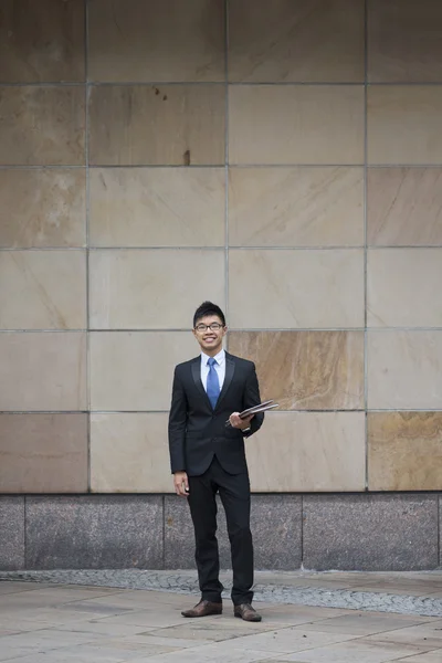 Asian businessman outside office building.