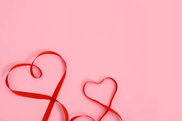 Walentynki Krzywe Czerwonej Wstążki Kształcie Serca Różowym Tle Świąteczne Tło — Zdjęcie stockowe