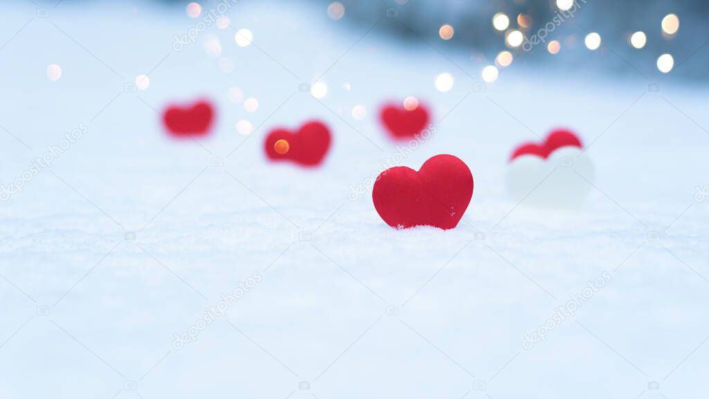 heart on snow, concept valentine's day holiday background, bokeh from light garlands new year.