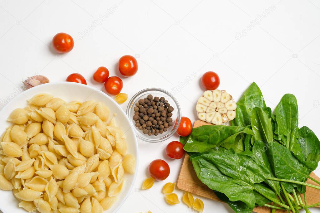 ingredients for oven-baked feta cheese with tomatoes and pasta, pepper garlic on a light background top view.