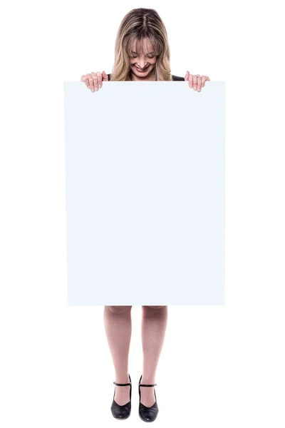 Businesswoman hiding herself with placard — Stock Photo, Image