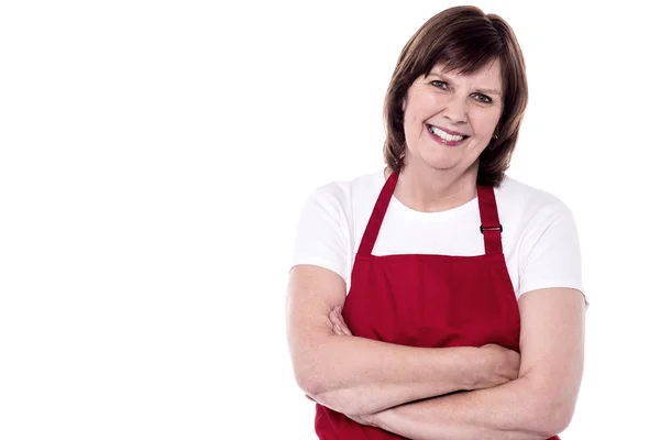 Senior woman chef in red apron — Stock Photo, Image