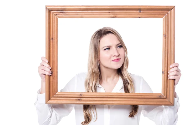 Confused woman holding an old frame — Stock Photo, Image