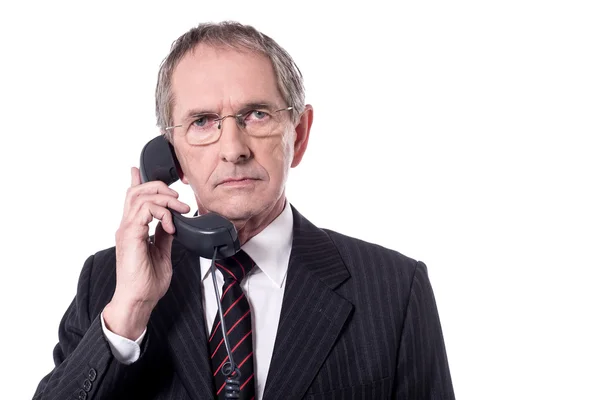 Angry businessman talking on telephone — Stock Photo, Image