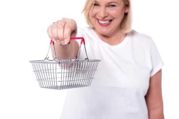 Woman showing mini shopping basket — Stock Photo, Image