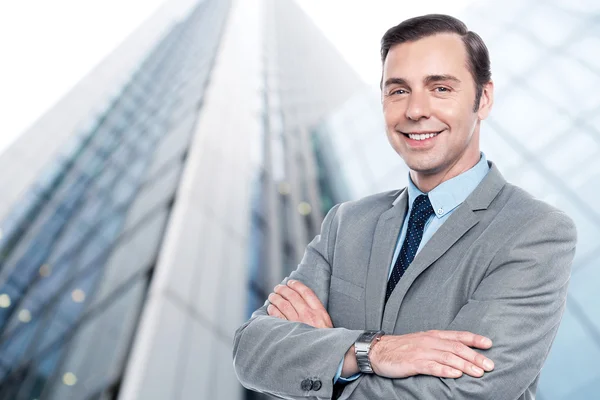 Handsome elegant businessman with crossed arms — Stock Photo, Image