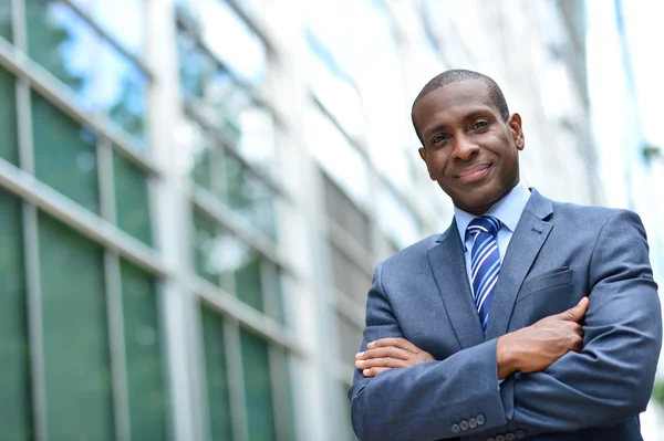 African business man keeping arms crossed — Stock Photo, Image