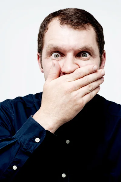 Man covering his mouth with his hand — Stock Photo, Image