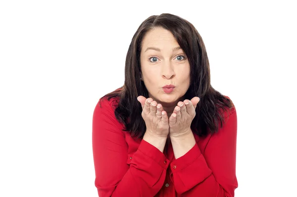 Middle aged woman blowing kiss — Stock Photo, Image