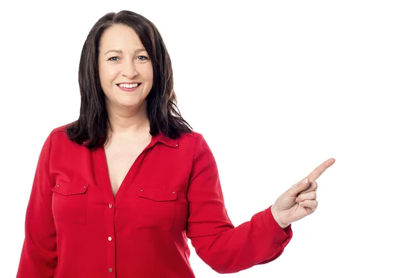 Woman pointing to copy space area — Stock Photo, Image