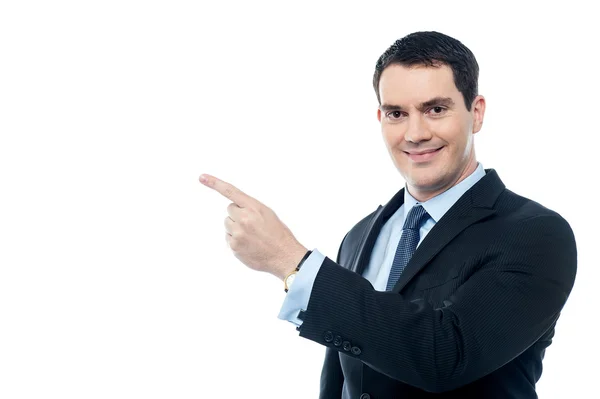 Smiling businesman pointing at something — Stock Photo, Image