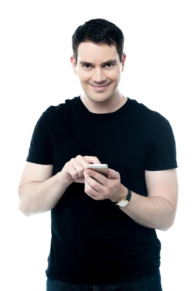 Lächelnder Mann liest SMS auf Smartphone — Stockfoto
