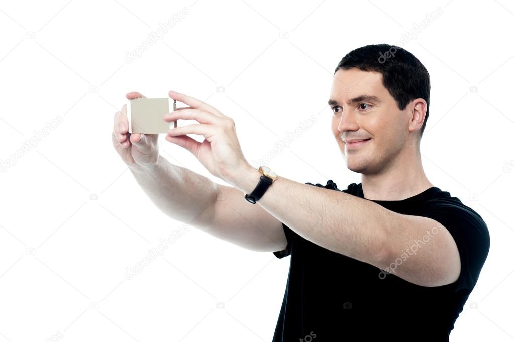 Handsome smiling man taking a selfie