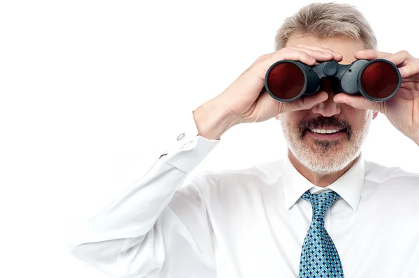 Businessman viewing through binocular — Stock Photo, Image