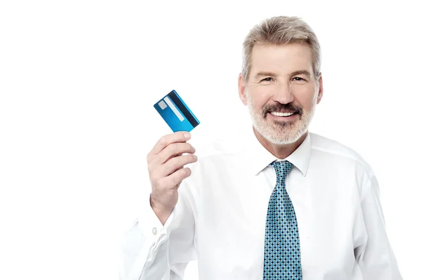 Businessman holding new credit card — Stock Photo, Image