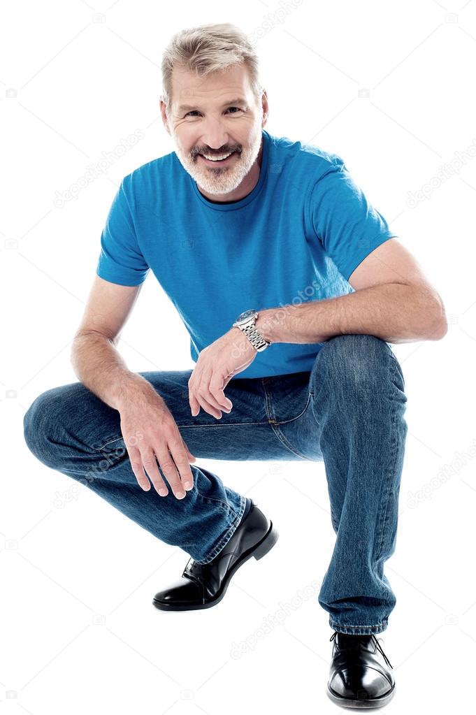 Man crouching down and smiling