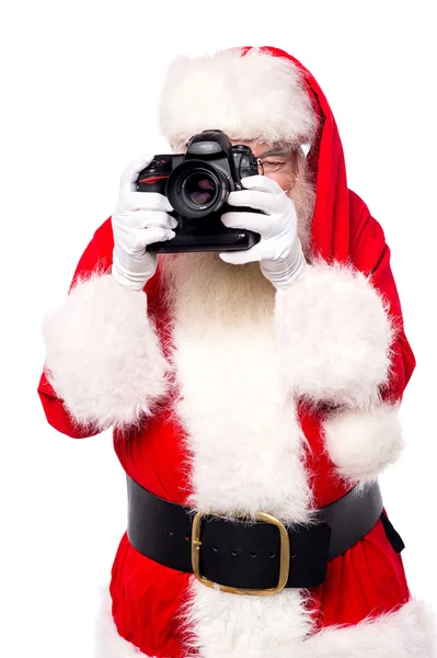 Santa claus nemen van foto 's — Stockfoto