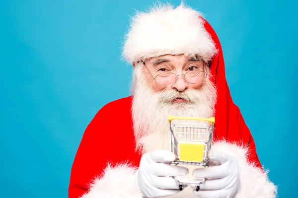 Santa claus holding shopping cart — Stock Photo, Image