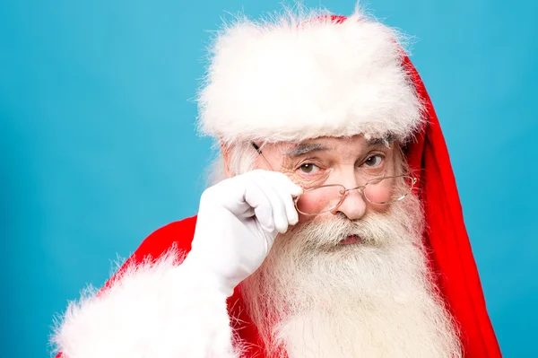 Happy santa claus with eyeglasses looking — Stock Photo, Image