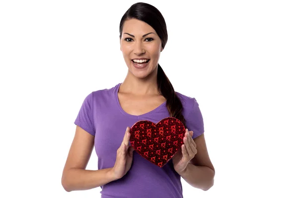 Woman holds heart shape gift box — Stock Photo, Image