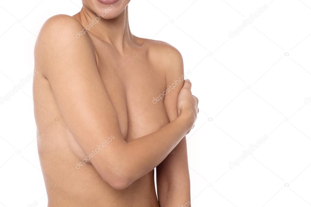 woman covers her bare breasts