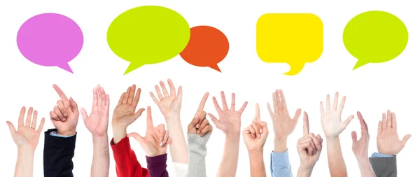 Hands with colorful speech bubbles — Stock Photo, Image