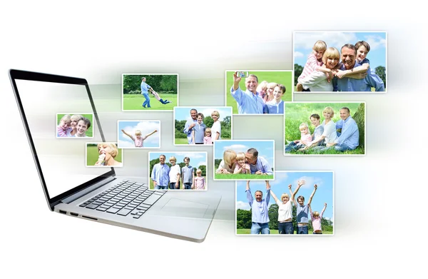 Pictures flying out of laptop screen — Stock Photo, Image