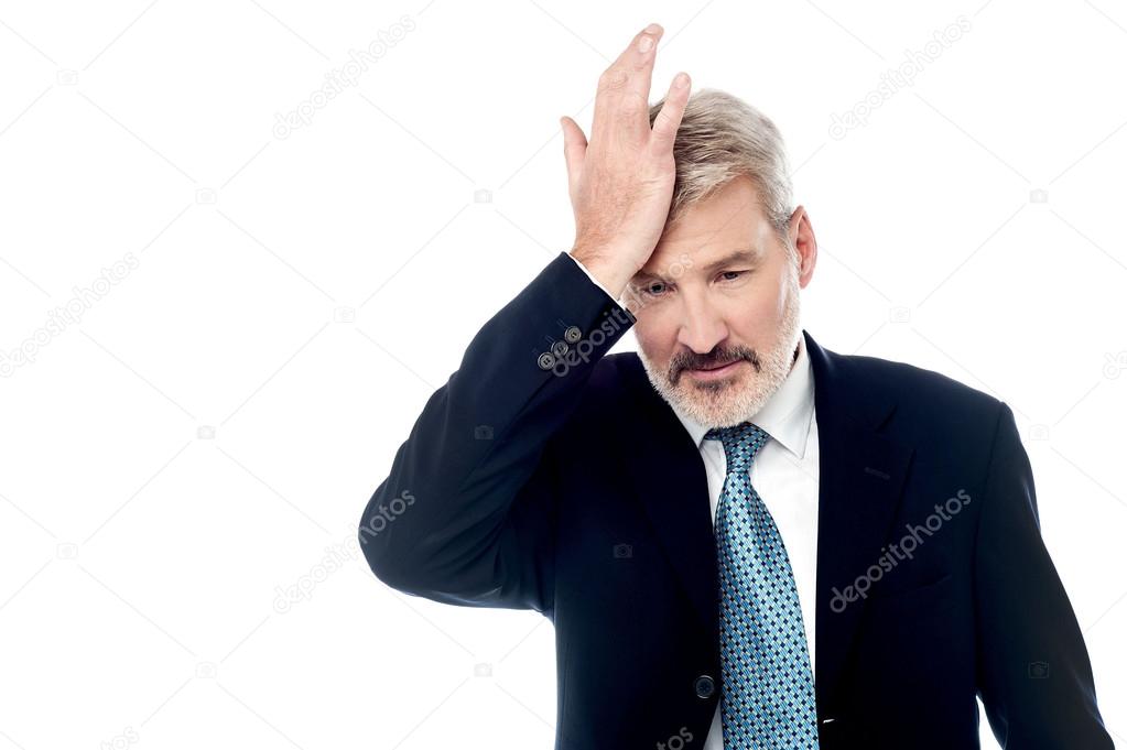 Businessman slapping his head