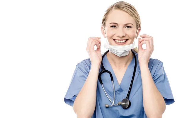 Doctor removing surgical mask — Stock Photo, Image