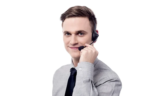 Business executive talking over headphones — Stock Photo, Image