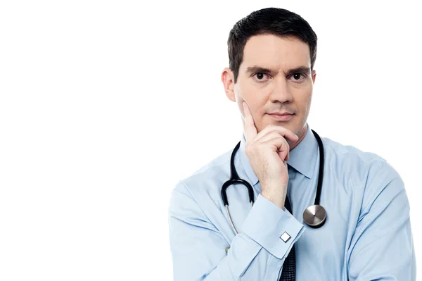 Doctor with hand on chin — Stock Photo, Image