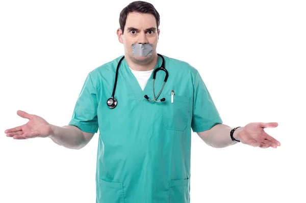 Male doctor mouth covered — Stock Photo, Image