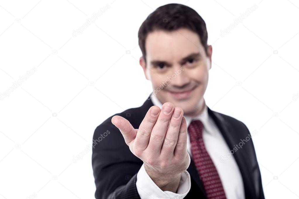 Businessman with hand beckoning someone Stock Photo by ©stockyimages  65418771