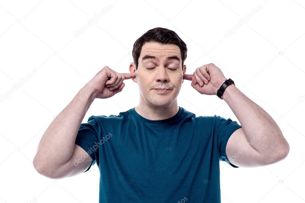 Man plugging ears with fingers