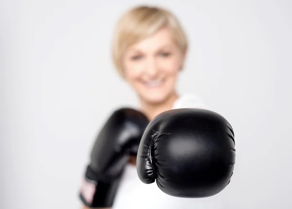 Vrouw met zwarte bokshandschoen voor beginners — Stockfoto